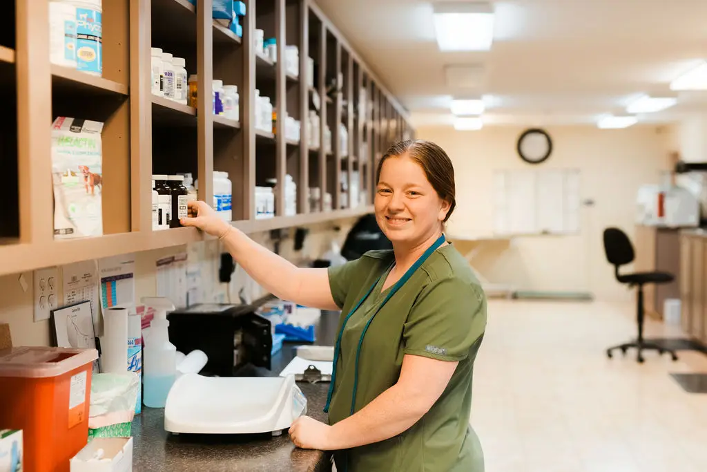 A vet tech smiles while working on laboratory diagnostics at Tri-County Veterinary Clinic.
